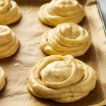 Cloud bread batter piped onto parchment before baking