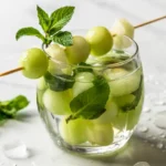 Mint Melon Mojito Mocktail recipe card with melon slice
