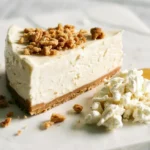 Individual slice of no-bake cottage cheese cheesecake garnished with crumble